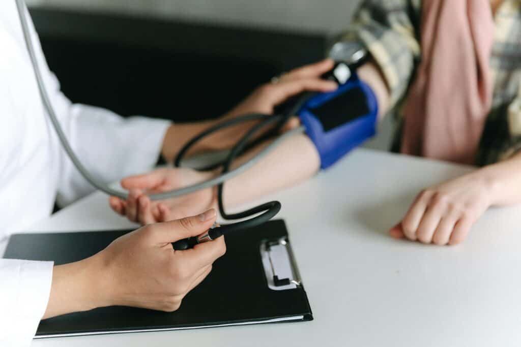 Pexels-photo-7659564-7659564 - What's Vegetarian? Close-up of a Medical Professional Measuring a Patient's blood pressure at a clinic.