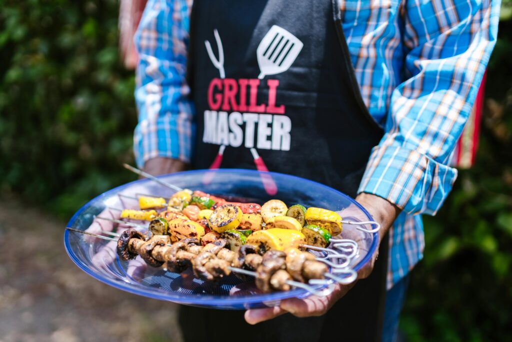 Pexels-photo-8523154-8523154 - What's Vegetarian? a Grill Master Holding a Plate of Colorful Grilled Vegetable Skewers Outdoors.