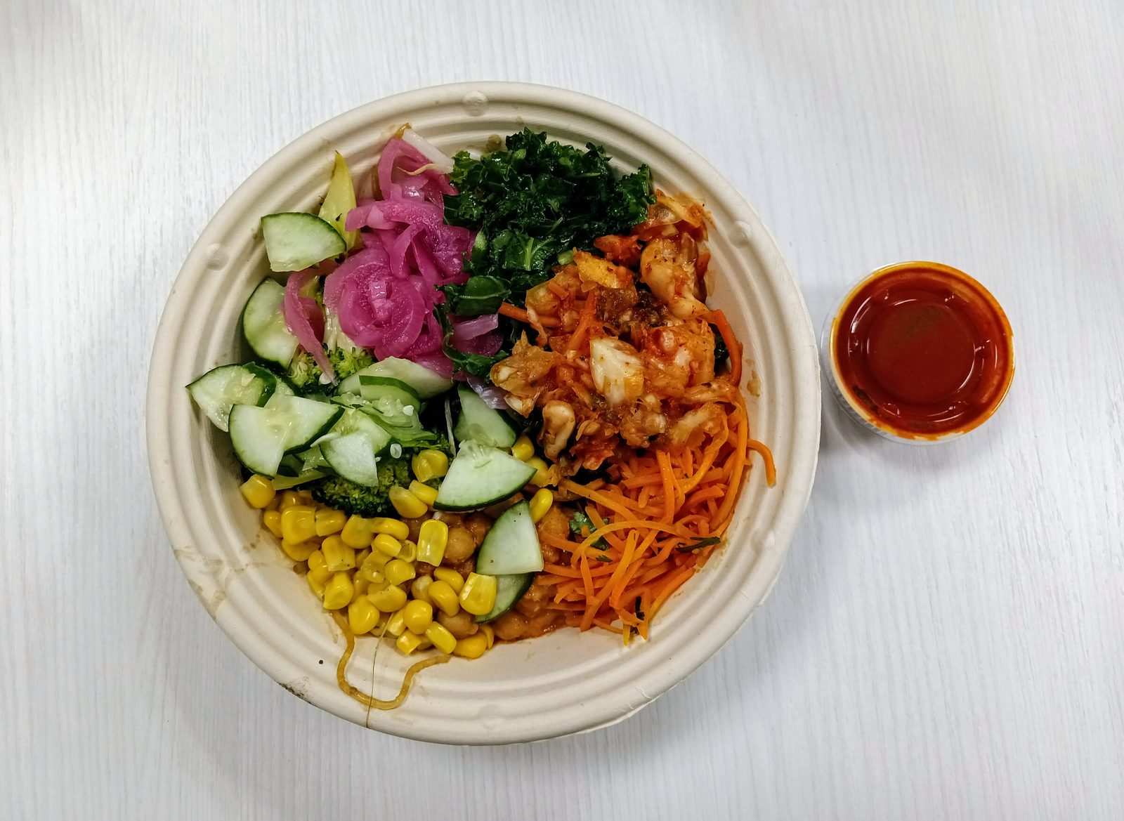 Bibibop vegetarian options: a veggie bowl with kimchi, cucumber, pickled onion, and gochujang sauce