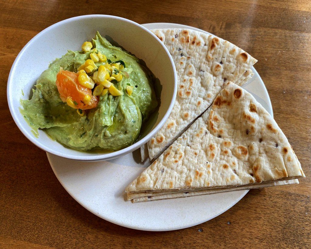 Avocado hummus with pita, one of the Flower Child vegetarian options that is fully vegan