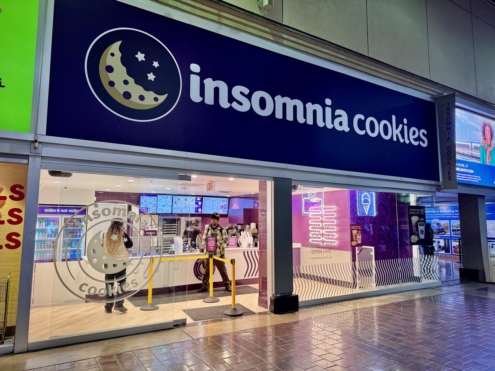 Insomnia Cookies vegetarian options on the menu board at a store counter