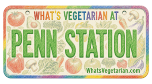 Colorful sign reading "WHAT'S VEGETARIAN AT PENN STATION" with vegetable drawings and URL WhatsVegetarian.com at the bottom.