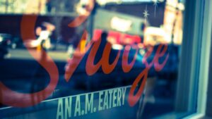 Snooze, an A.M. Eatery storefront window sign