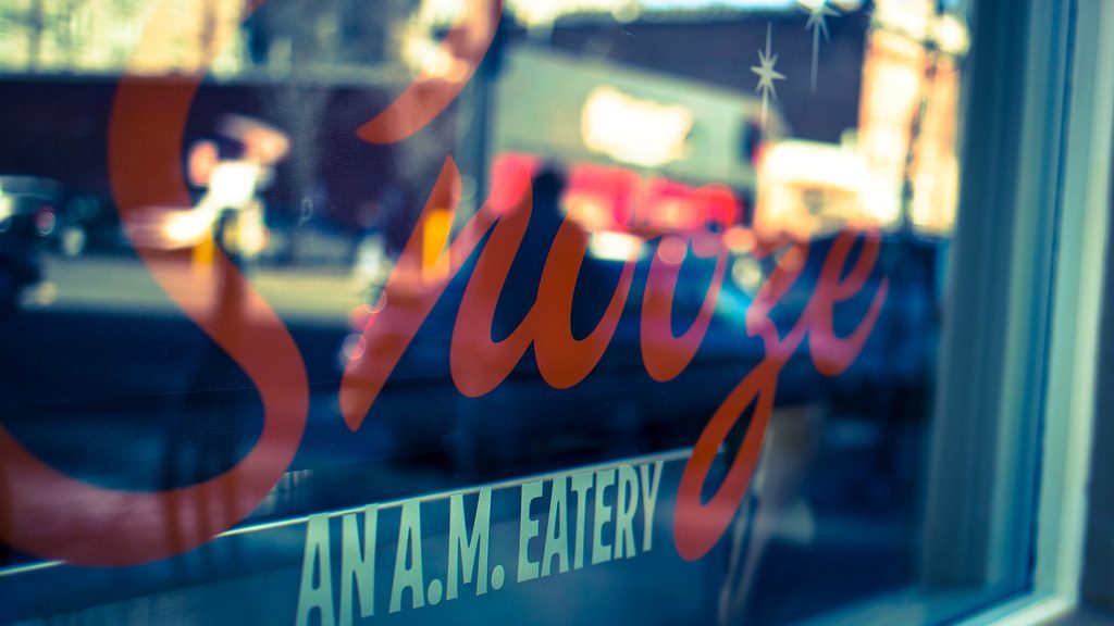Snooze, an A.M. Eatery storefront window sign