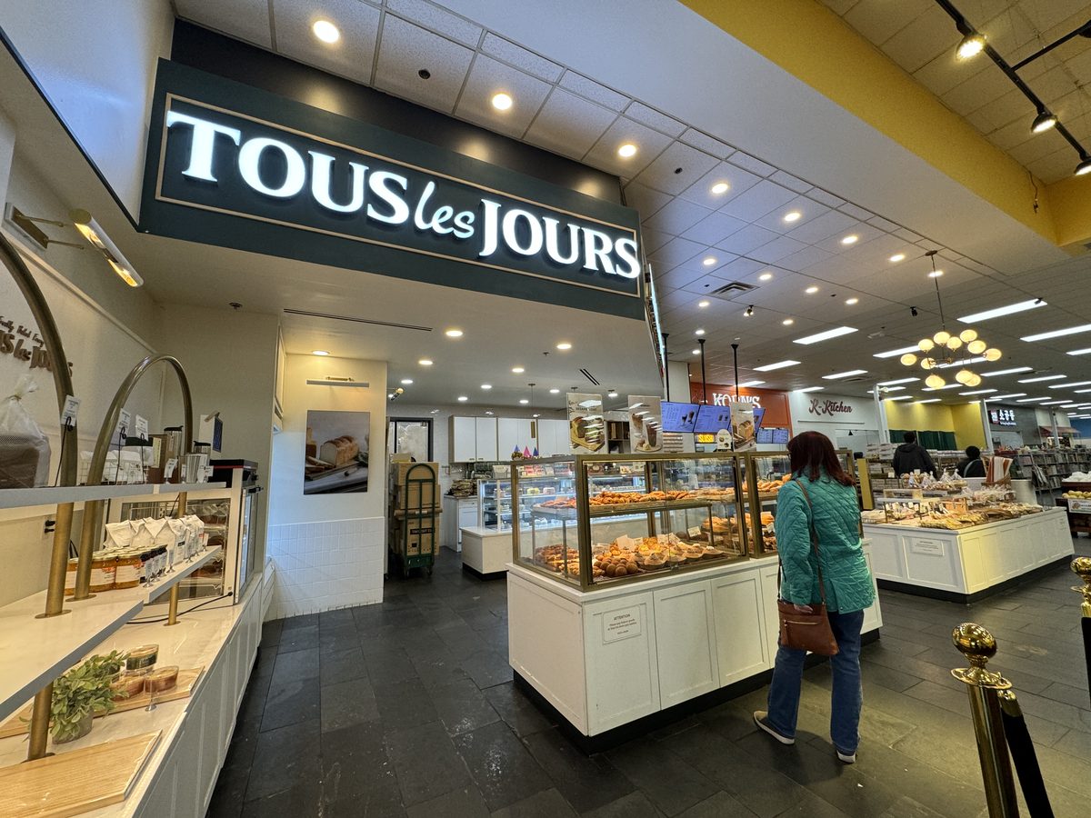 Tous Les Jours bakery-cafe storefront sign and pastry case
