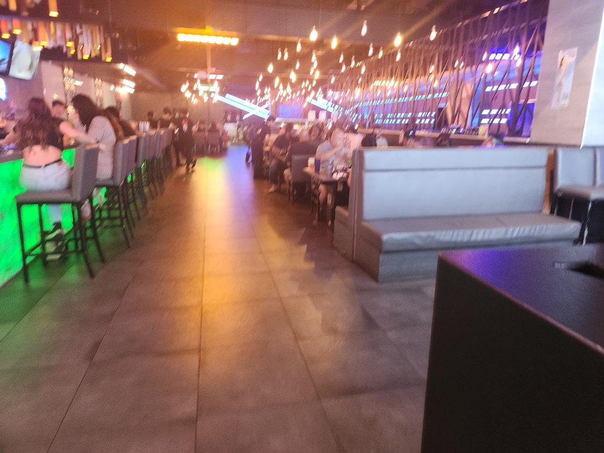 Inside a KPOT restaurant dining room in East Brunswick, New Jersey, showing the individual hot pot burners