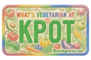 Colorful illustrated plate sign reading 'WHAT'S VEGETARIAN AT KPOT' with vegetable drawings around the border and 'WhatVegetarian.com' at the bottom.