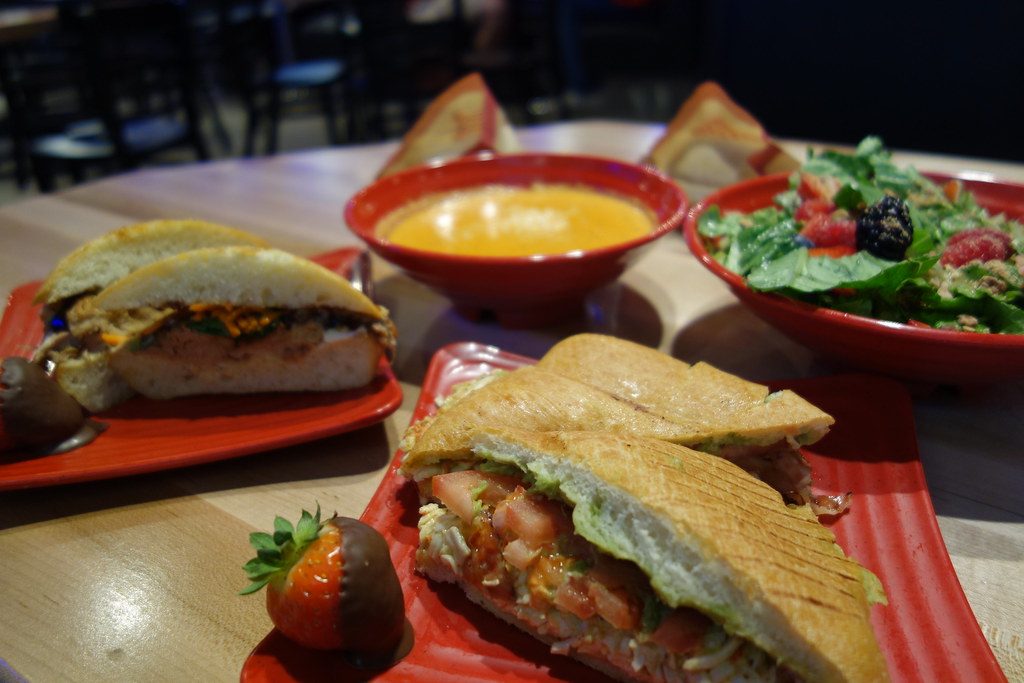 Cafe Zupas vegetarian options sandwich, soup, and salad on a table